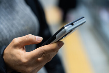 a woman's  hands holding a smartphone