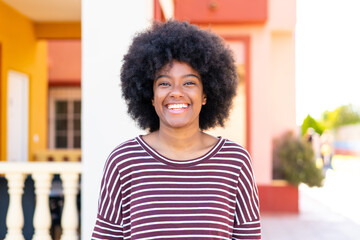 Fototapeta premium African American girl at outdoors With happy expression