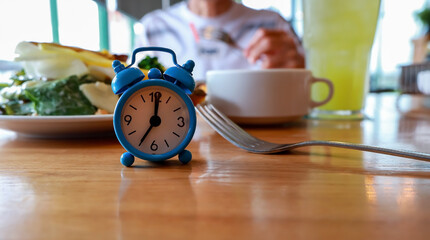 Blue Alarm Clock Waiting for the IF Meal Intermittent Fasting Concept