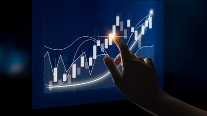 A hand interacts with a modern digital chart displaying financial trend and data analysis against a dark background, symbolizing investment and business growth. Impute