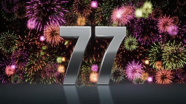 Silver number 77 with fireworks in the background. Festive scene for birthday or anniversary party