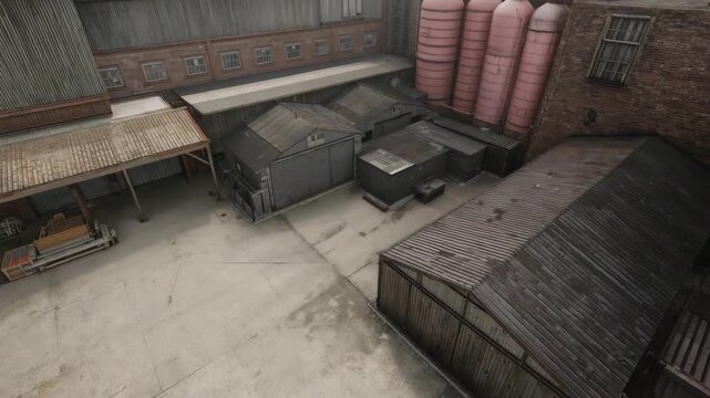 Industrial storage yard with stacked containers and tanks inside brick warehouse courtyard