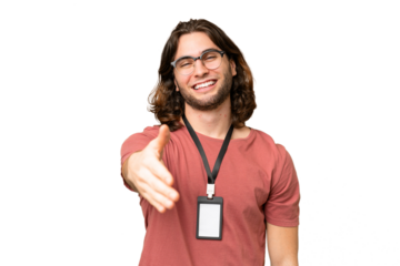 Young handsome man with ID card over isolated background shaking hands for closing a good deal
