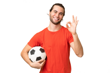 Young handsome man isolated on green chroma background with soccer ball and making OK sign