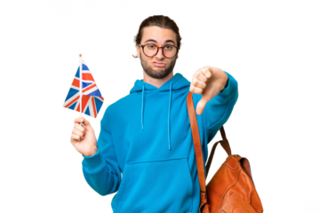 Young handsome man holding an United Kingdom flag over isolated background showing thumb down with negative expression