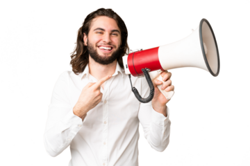 Young handsome man over isolated chroma key background holding a megaphone and pointing side