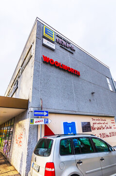 ISERLOHN, GERMANY &mdash; DECEMBER 12, 2025: Exterior view of a shopping center building with Woolworth and Edeka signs in the Letmathe district.