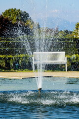 Giardino con zampilli di fontana e panchina