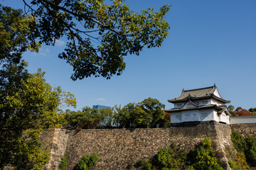 Osaka Castle Osaka-jo: A Japanese Fortress With Green Roofs Against a Clear Blue Sky