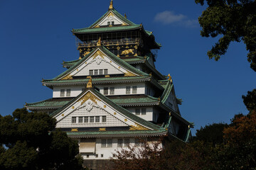 Osaka Castle Osaka-jo: A Japanese Fortress With Green Roofs Against a Clear Blue Sky