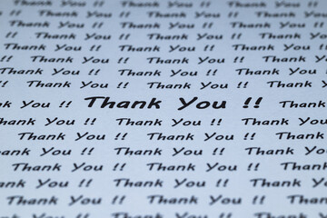 The words "Thank You" are written on a piece of white paper.