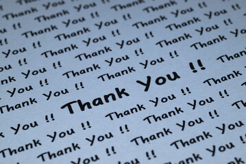 The words "Thank You" are written on a piece of white paper.