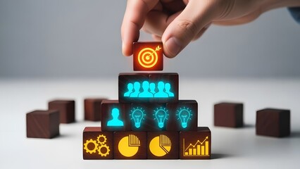 Hand placing a target block on stacked wooden cubes symbolizing business strategy