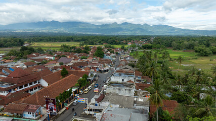 Aerial view of rooftops and distant hills

