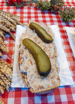 "Pajda ze smalcem" is a traditional Polish sandwich with thick slice of hearty bread, spread with a savory spread made of rendered pork fat. Served with pickled cucumbers