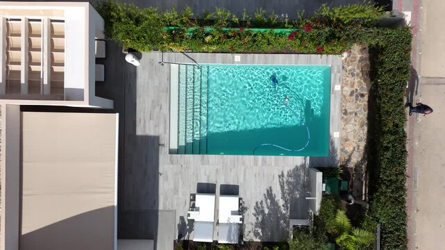 Drone ascending from private pool to reveal villas and construction at La Finca urbanization