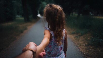 Follow me, a young girl leads the way down a tree-lined path in a park