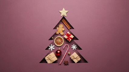 Festive christmas tree concept with ornaments and gifts on a pink background
