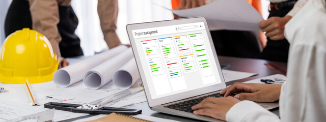 Project planning software for brisk business project management on the computer screen showing timeline chart of the team project