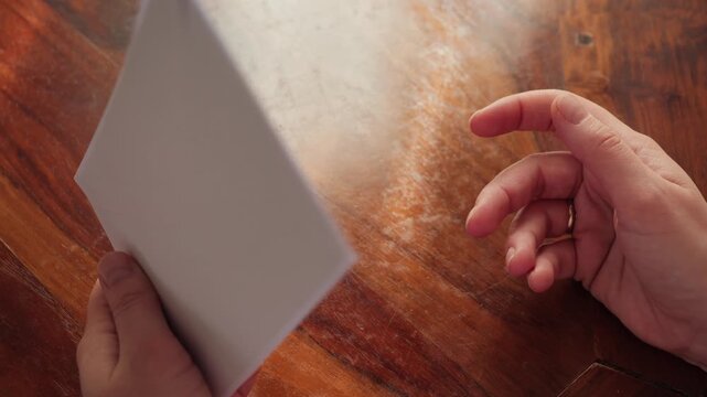 A woman holds an envelope with a letter in her hands before sending it to the post office. She checks the information. High quality 4k footage