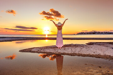 A woman looking the sunset at the beach Neos Marmaras in Chalkidiki, Greece