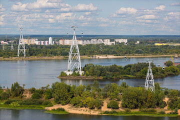 Nizhny Novgorod Cableway. The cable car crosses the Volga River between Nizhny Novgorod and Bor. Summer landscape with high support towers of the cable car. In the distance is the town of Bor. Russia.