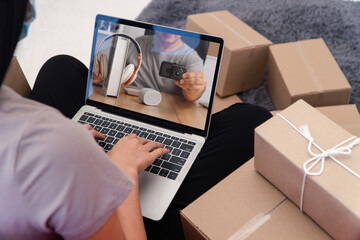 Online Shopping,  E-commerce Scene: A person engages in online shopping, surrounded by parcels and a laptop showcasing a purchase, symbolizing the ease and convenience of digital retail.