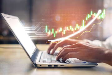 Close-up of hands typing on a laptop while a financial growth chart overlay appears, illustrating the concept of data-driven business analysis and success analytics. Impute