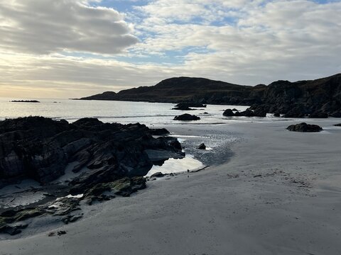 Beautiful wild beach Isle of Mull Scotland Uisken the beautiful rocky and sandy shore sunrise with water pools reflect sun light  vast ocean on horizon with wildlife  and blue sky in Winter no people