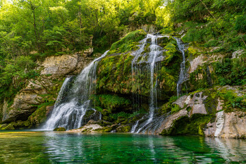 Fototapeta premium Majestic Virje Waterfall cascading through lush Soca Valley Triglav National Park Slovenia