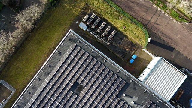 Aerial drone view of large scale cutting-edge technology and futuristic infrastructure of a large-scale data center in Milton Keynes, UK. AI cloud quantum computing.  - Powered by Adobe