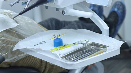 Sterile dental instruments and syringes on the doctor's workbench