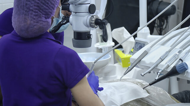 Dentist working with a microscope in a modern dental clinic