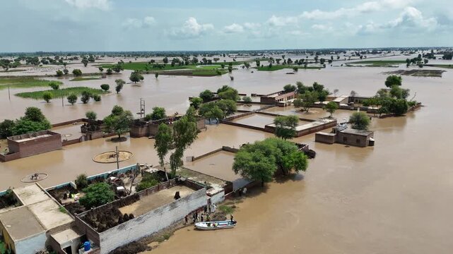 Flood in Punjab Drone aerial showing flooded fields aerial view of floodwaters overflowing onto farmland road in Punjab Pakistan flooded villages 4k