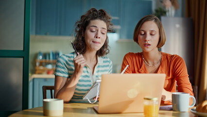 Displeased women finish videocall closing laptop in apartment kitchen closeup.