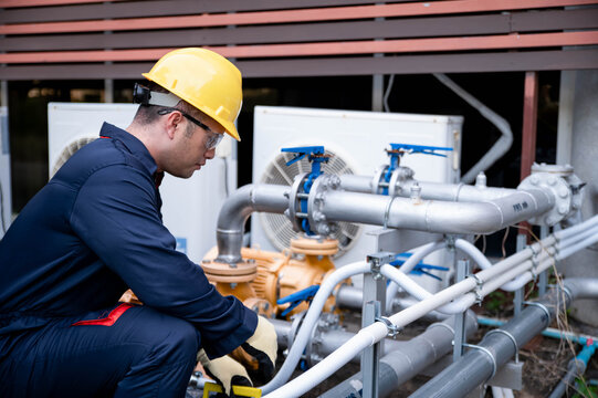 A chief maintenance worker is inspecting the high-pressure water pump system of an industrial plant for malfunctions.
