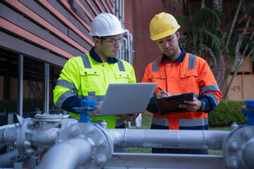 A specialist engineer and an inspector are discussing installing an additional high-pressure water...