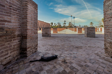 Historic Outdoor Archaeology Site With Brick Pillars, Ruins, Palm Trees, And Open Sky, Marrakesh, Morocco