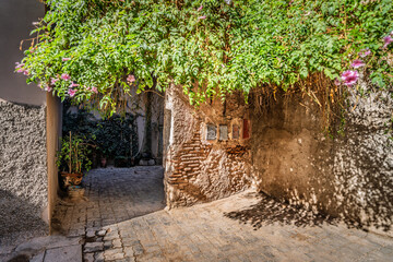 Naklejka premium Narrow Brick Tunnel Walkway With Group Of People Exploring Dim Underground Passage, The Soukh, Marrakesh, Morocco
