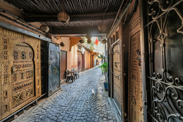 Narrow Brick Tunnel Walkway With Group Of People Exploring Dim Underground Passage, The Soukh, Marrakesh, Morocco