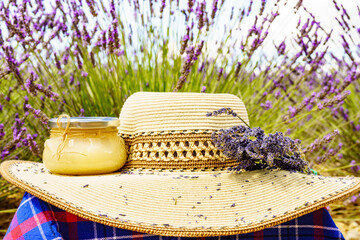 Summer hat and jar with honey at lavender field. Holidays in France.