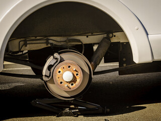 Car in service repairing. Detail of wheel assembly on automobile