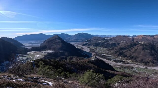 Panoramic aerial-style view over Monte Giaideit and the Tagliamento valley in Friuli Venezia Giulia, Italy, on a clear winter day.