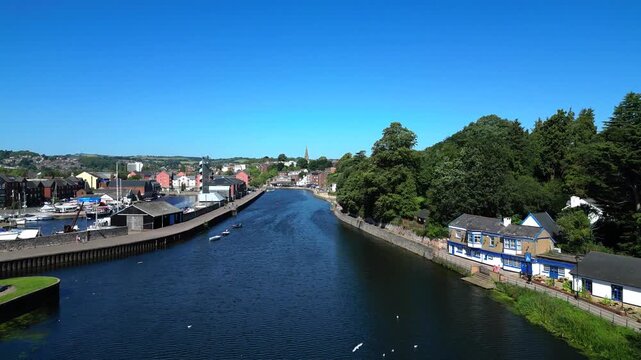 Exeter, Devon, England: DRONE VIEWS: Low angle shots of the River Exe and Exeter Quays showing residential and commercial buildings either side of the river. Exeter is a cathedral city and county town