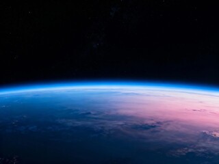 Fototapeta premium Earth's horizon from space with atmospheric glow and starry background