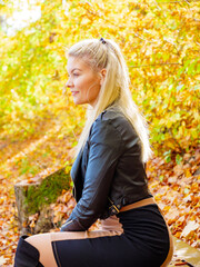 Fashion woman relaxing in autumn park