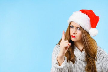 Woman threatens with finger, serious face expression