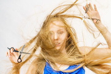 Girl with scissors for haircutting