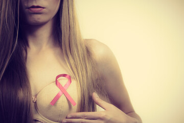 Woman chest in bra, pink cancer ribbon