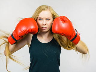 Woman in gloves playing sports boxing